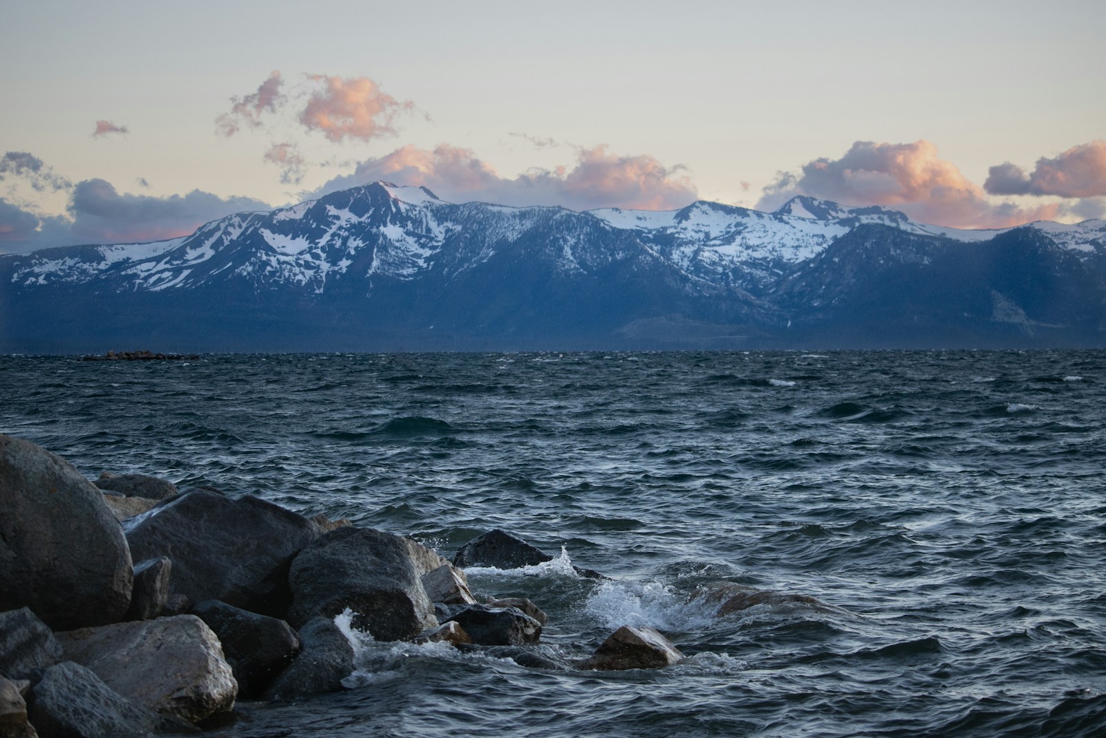 a large body of water with mountains in the background
